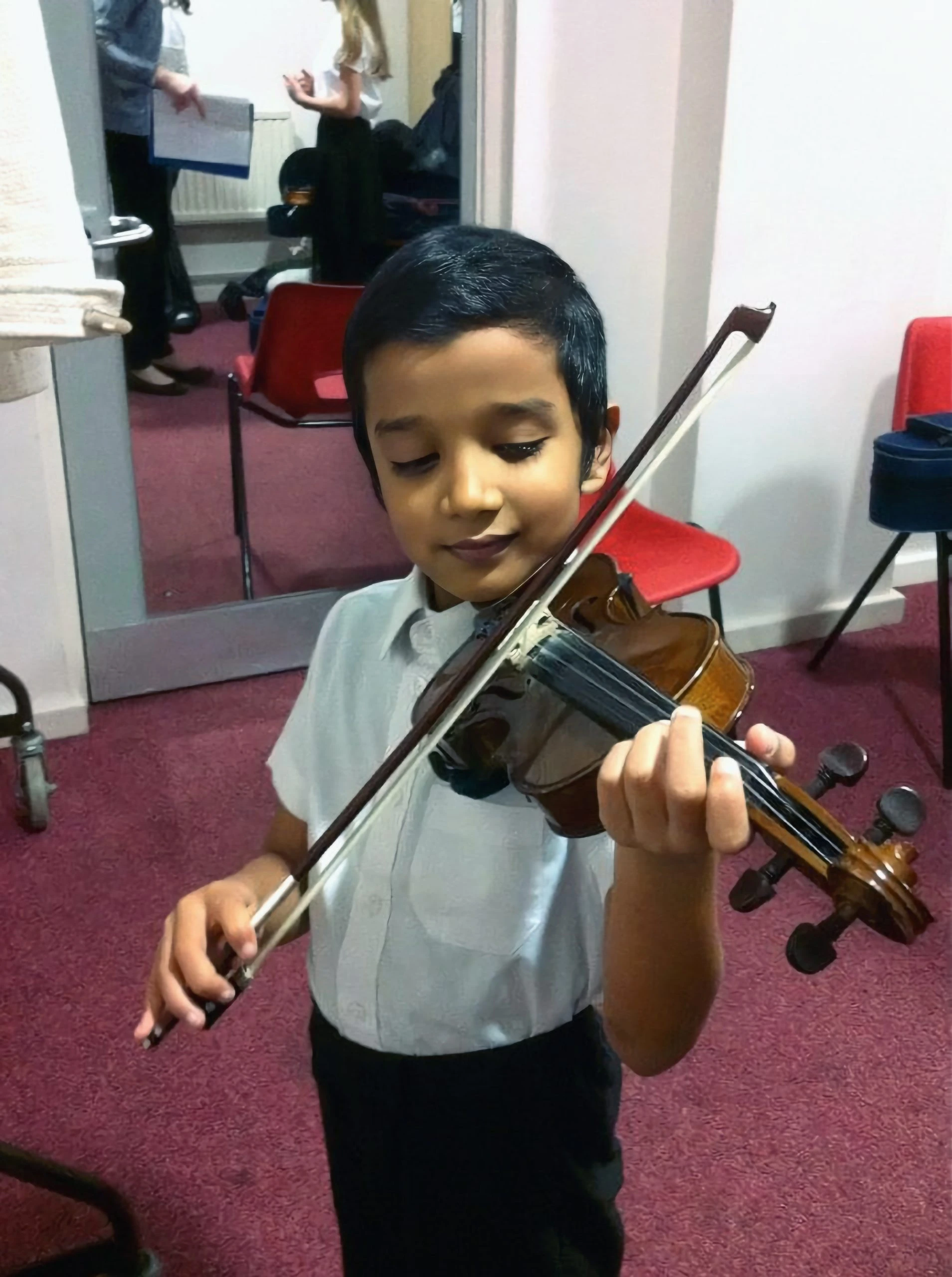 Vivek Dinesh Ramanan playing the violin as a child